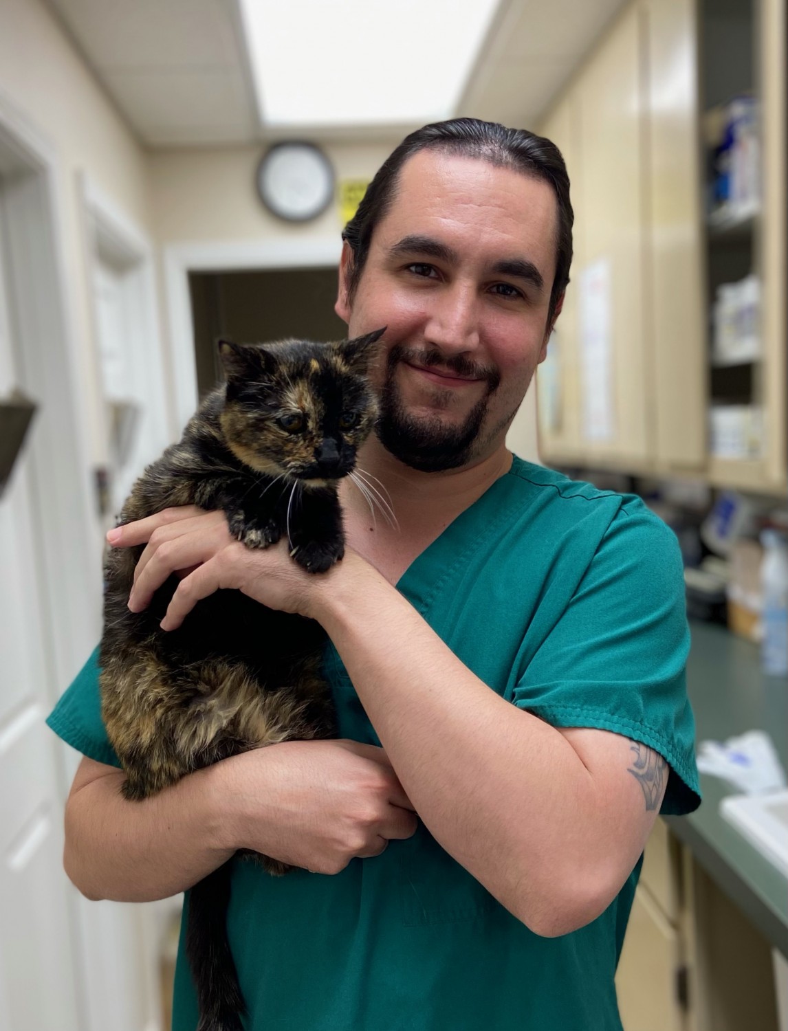 Dr. Joseph Banuelos with calico cat
